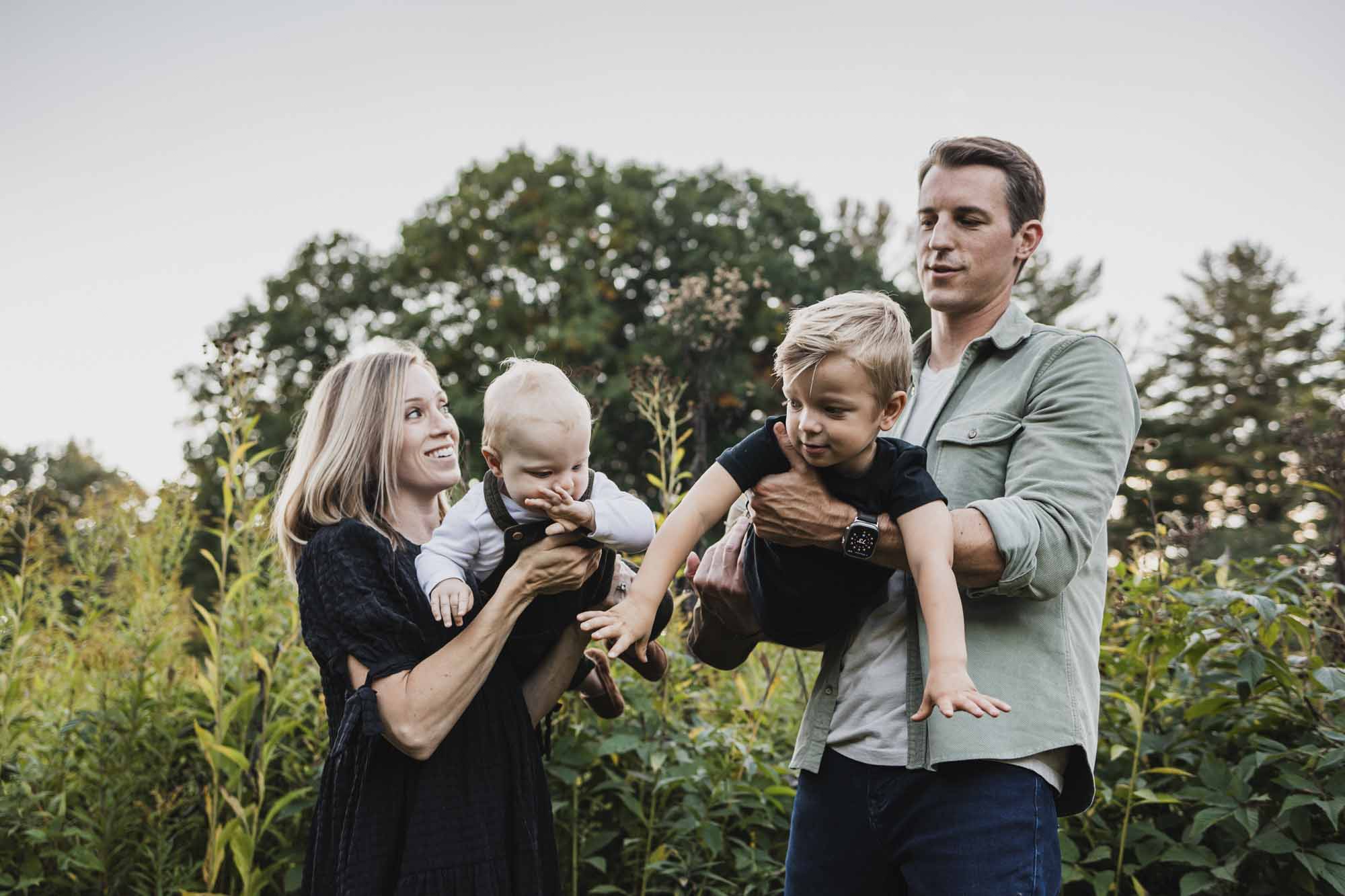 Family of four in field during family photoshoot