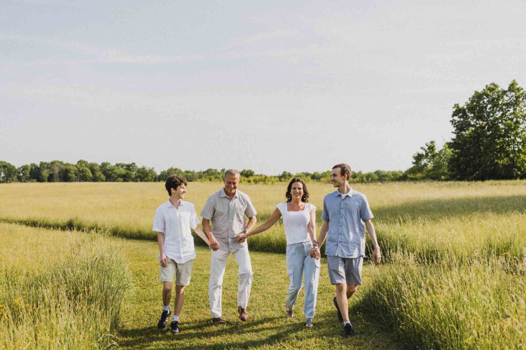 Mom, dad, and sons in large field