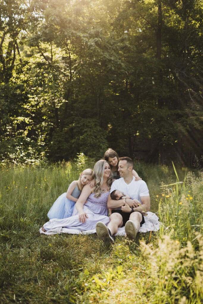 Family sitting in field during spring family photos