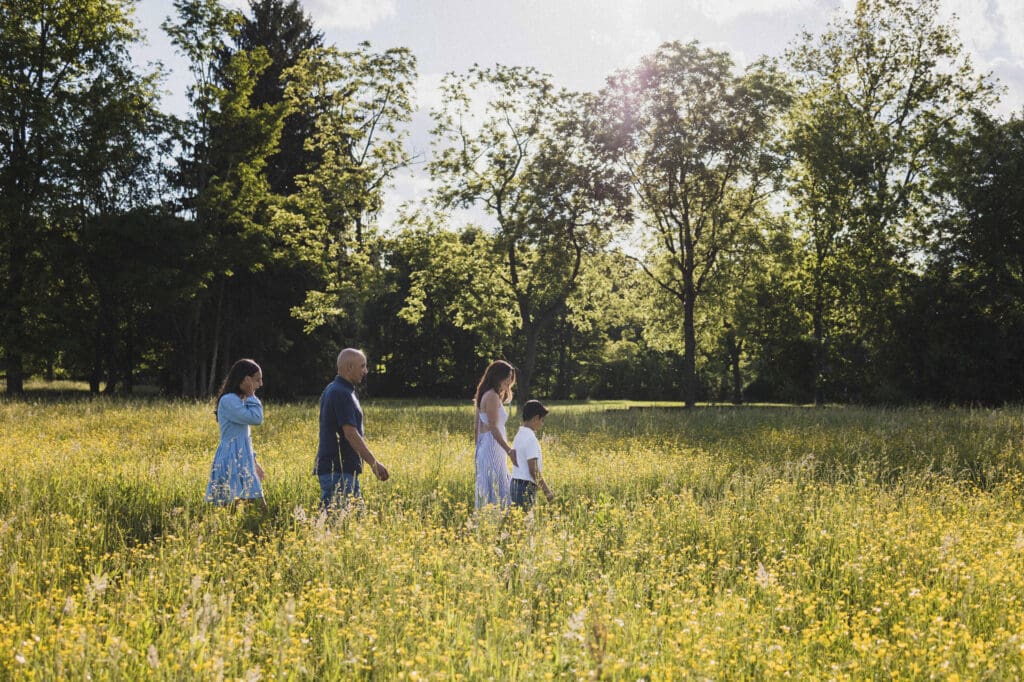 Family walking through spring meadow