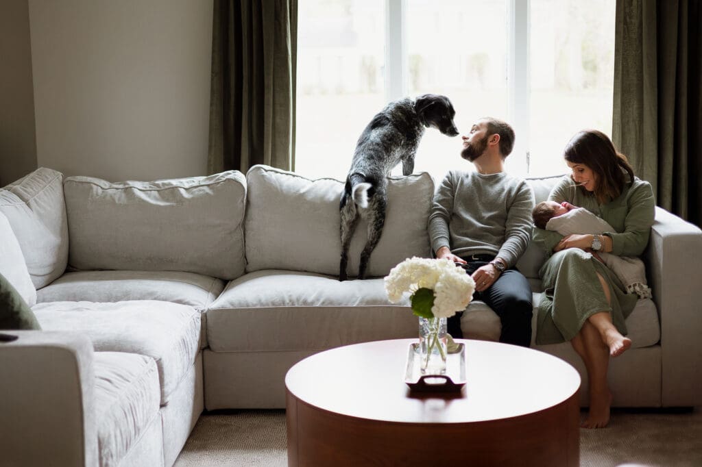 Family sitting in living room during Chagrin Falls newborn photographer session
