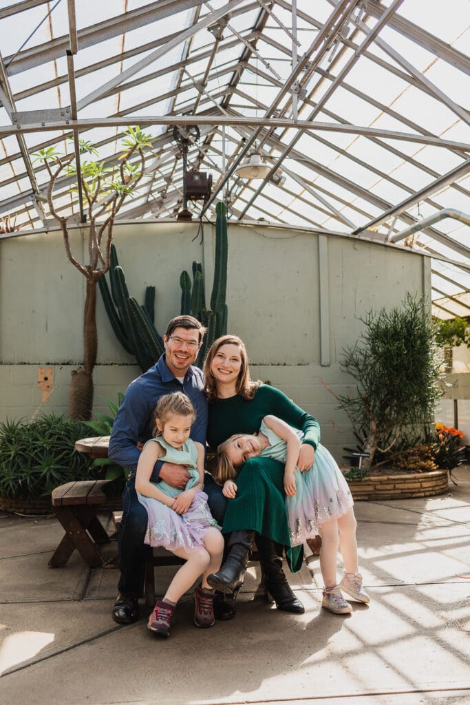 Family sitting at picnic table at Rockefeller Park Greenhouse in Cleveland, OH
 