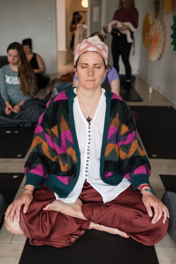 Cleveland holistic doula Jena Ashwill meditating during Mama Bird Hendry Breastfeeding Retreat at Pop Life CLE
