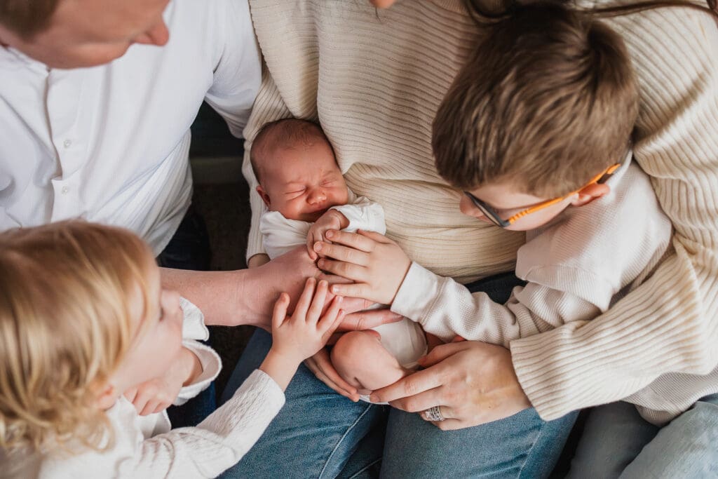 Family holding newborn baby during Pepper Pike in-home newborn photography session
