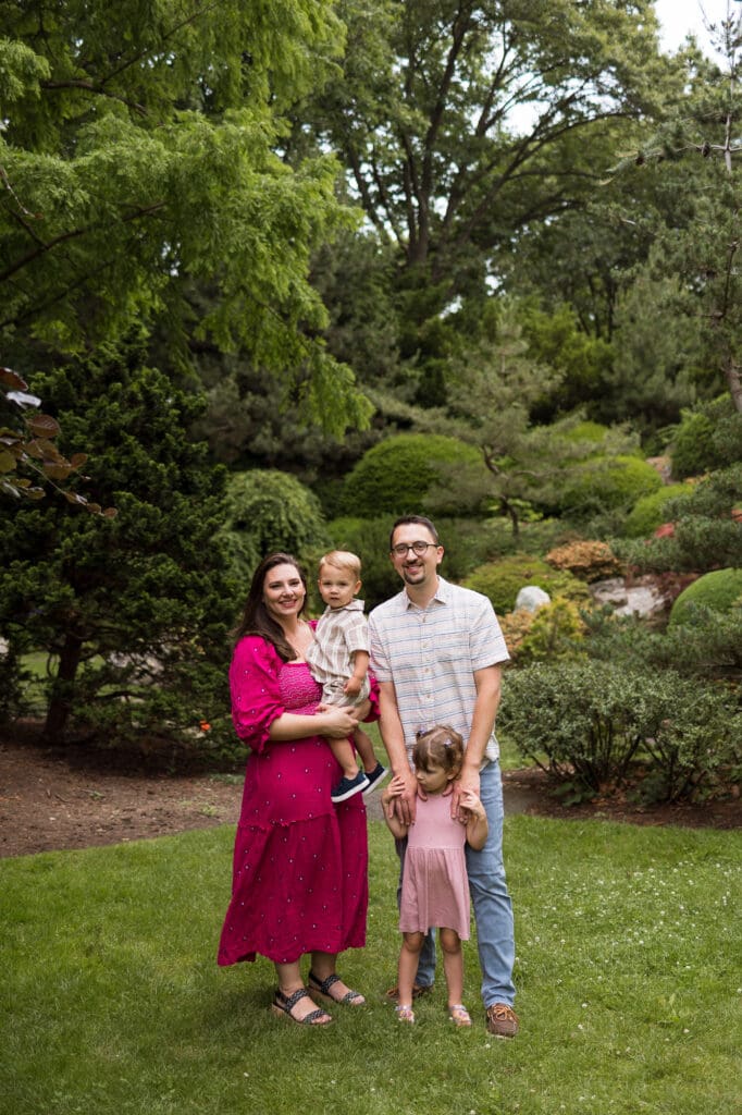 Family smiling at camera during photo session at the Sunken Garden
