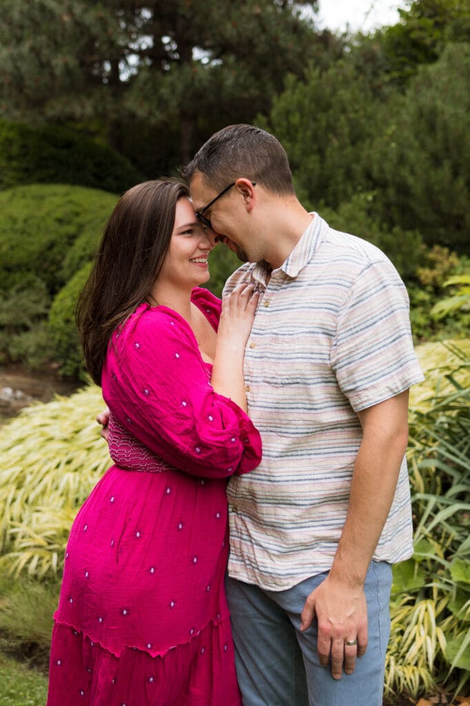 Mom and dad touching foreheads during family photo session at Cleveland Botanical Garden