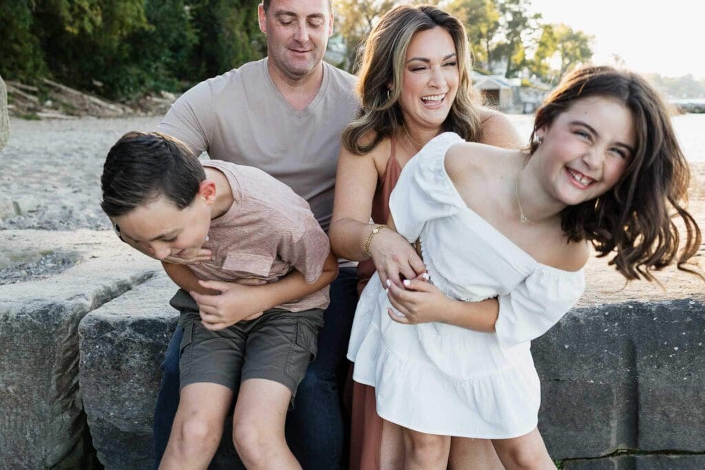 Family laughing on the beach in Cleveland, OH.