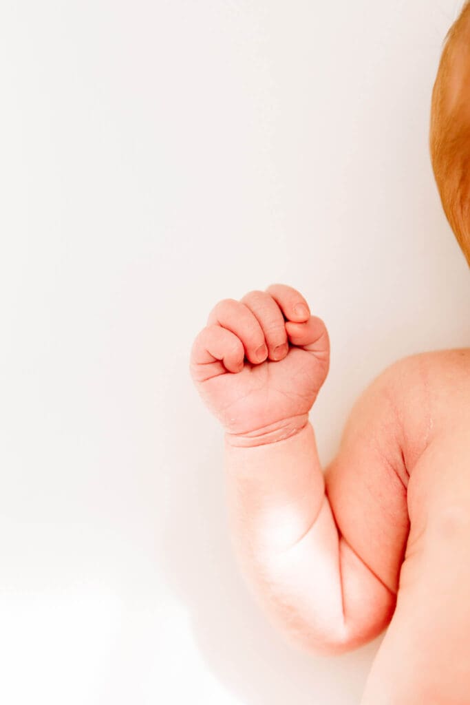 A close-up of a newborn’s hand, perfectly curled—capturing the tiny details that define the newborn stage.