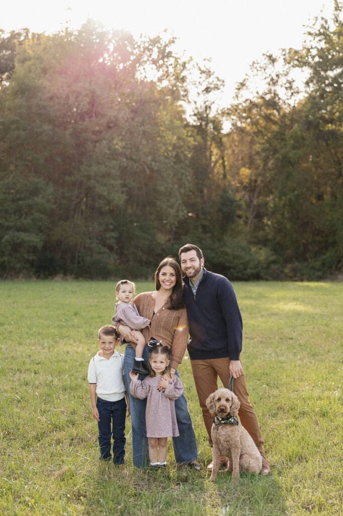 A family of five standing in a field in Moreland Hills during a fall family photo session
